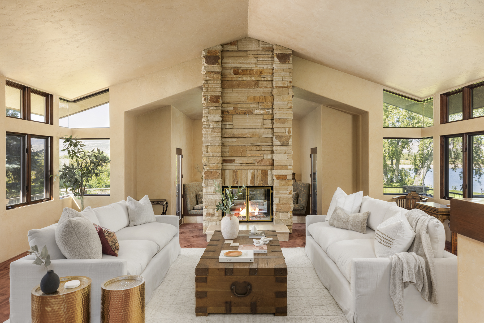 Living room with tall stone fireplace