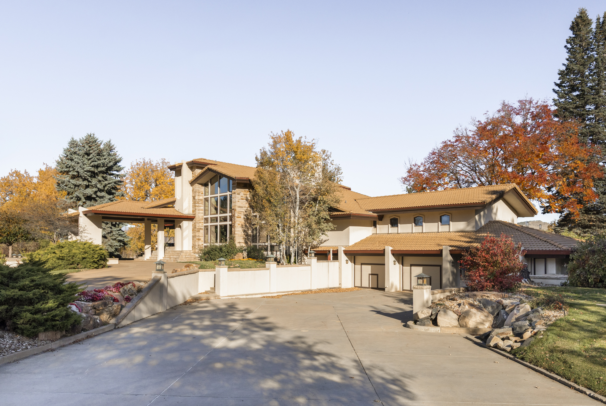 The residence exterior with drive and fall color