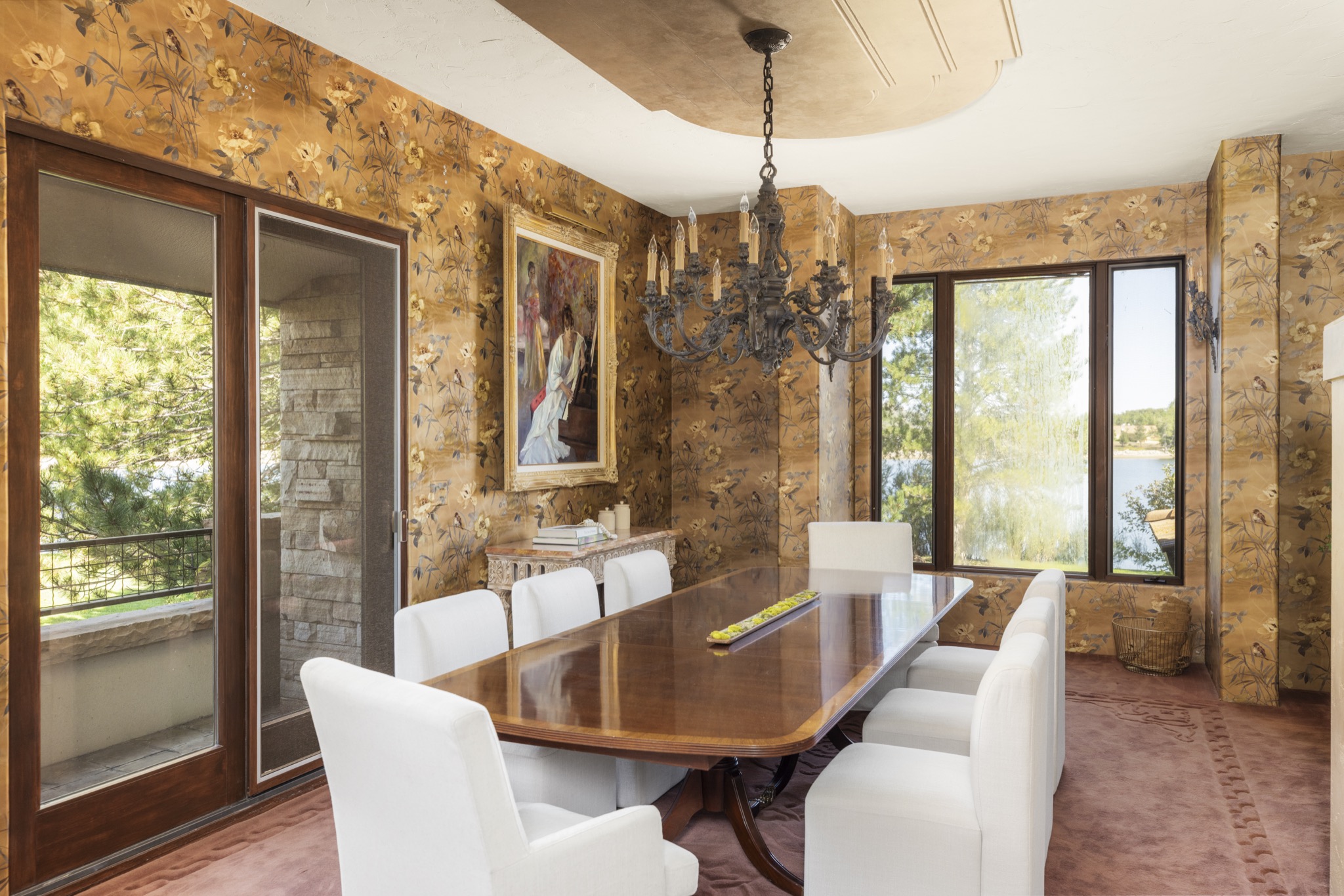 Dining room with chandelier and stone wall
